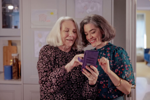 Woman and her mother in law looking at a phone