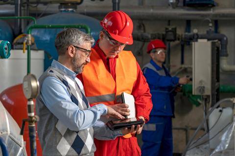 Construction workers reviewing a checklist